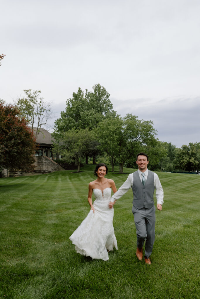 Watersedge wedding venue in Columbus, Ohio, bride and groom running